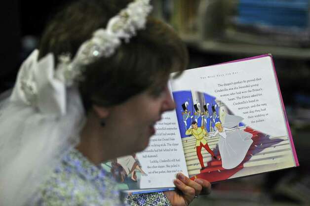 Lisa Witkowski wears the bridal veil from her 1994 wedding while reading the