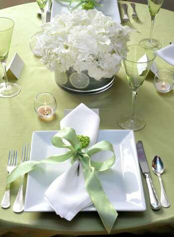  modern square plates and a celadoncolored cloth with white and green 