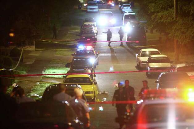  officers work a scene on July 14, 2011 after the fatal shooting ...