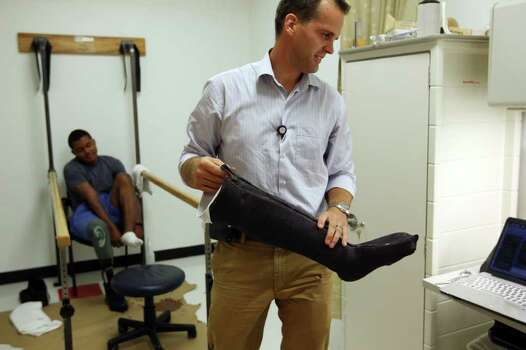 The Center for the Intrepid prosthetist Ryan Blanck carries a cast for ...