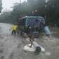 People push a stalled vehicle along a flooded street during typhoon.... photo: 1630335 slideshow 31095
