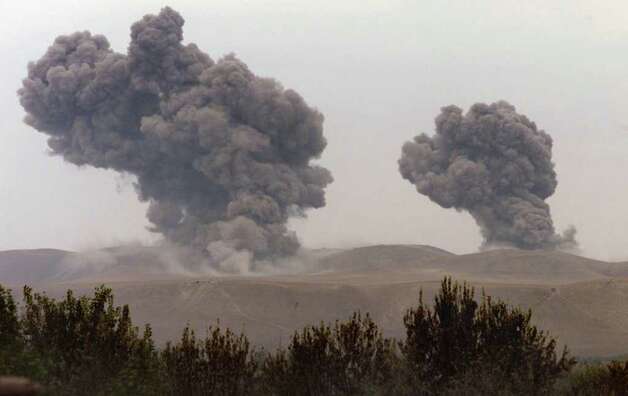 Bombs from a U.S. B-52 kick off an assault against the Taliban in northern Afghanistan, hitting Taliban tank positions in this October 2001 photo. Photo: JOSHUA TRUJILLO / SEATTLEPI.COM