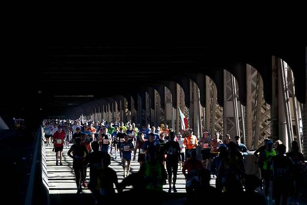 Runners jog across the Queensboro Bridge while competing in the New York City Marathon, Sunday, Nov. 6, 2011. (AP Photo/Andrew Burton) Photo: Andrew Burton, AP
