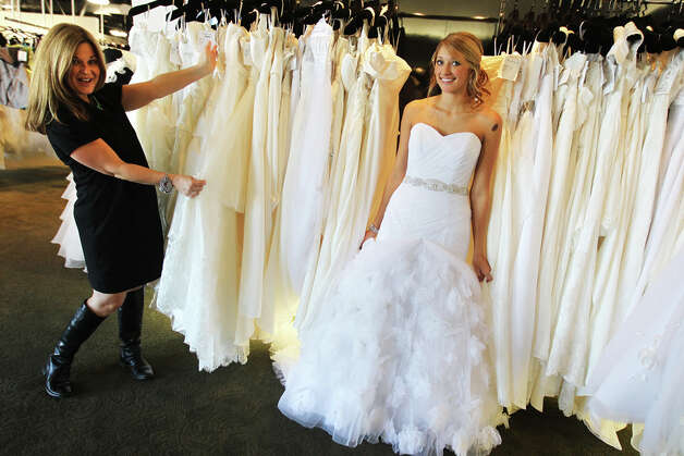 Giselle Drake a stylist at Impression Bridal models a gown as stylist and 