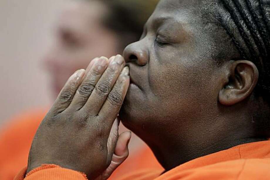 Elsie Bryant, 51, reacts as she hears Reverend Carolyn Dyson from the California Pacific - 920x920