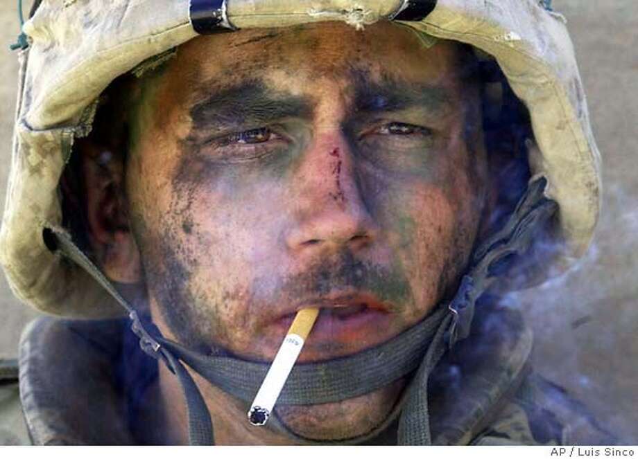 A member of Charlie Company of the U.S. Marines First Division, Eighth regiment, smokes a cigarette in Fallujah, Iraq, Tuesday, Nov. 9, 2004. U.S. forces punched into the center of the insurgent stronghold, overwhelming bands of guerrillas in the street with heavy barrages of fire and searching house to house in a powerful advance on the second day of a major offensive. (AP Photo/Los Angeles Times, Luis Sinco) ** MANDATORY CREDIT, , NO FOREIGN, NO MAGS, LOS ANGELES DAILY NEWS OUT, OC REGISTEROUT, VENTURA COUNTY STAR OUT, INLAND VALLEY DAILY BULLETIN OUT, SAN BERNARDINO SUN OUT ** Photo: LUIS SINCO