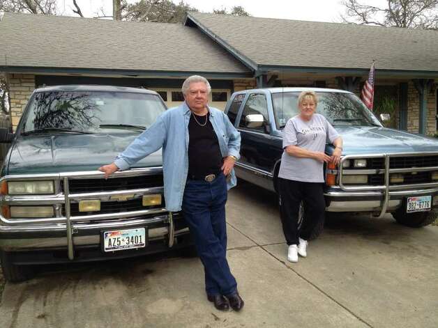 Jim and Gina Hoyer stand before their 1996 Chevy Suburban 450000plus 