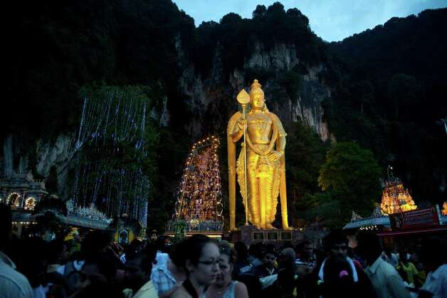 Hindu devotees make their way towards the Batu Caves to perform their religious rites before sunrise during the Thaipusam Festival on the outskirts of Kuala Lumpur on February 7, 2012. The Hindu festival of Thaipusam, which commemorates the day when Goddess Pavarthi gave her son Lord Muruga an invincible lance with which he destroyed evil demons, is celebrated by some two million ethnic Indians in Malaysia and Singapore. Photo: SAEED KHAN, AFP/Getty Images / 2012 AFP