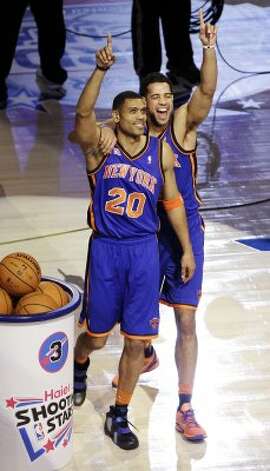 New York Knicks guard Landry Fields, right, celebrates with former Knicks guard Allan Houston (20) after winning the NBA All-Star Shooting Stars basketball competition in Orlando, Fla., Saturday, Feb. 25, 2012. (AP Photo/Chris O'Meara) (AP) / SA