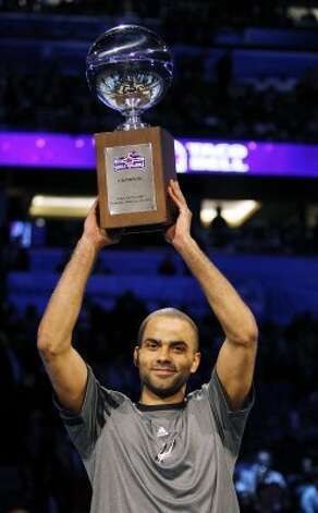 San Antonio Spurs' Tony Parker (9) holds the NBA All-Star Skills Challenge basketball competition trophy after winning the event in Orlando, Fla., Saturday, Feb. 25, 2012. (AP Photo/Lynne Sladky) (AP) / SA