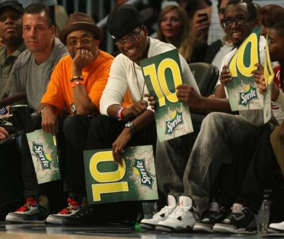Filmmaker Spike Lee, left and singer P. Diddy, right, enjoy the NBA basketball All-Star Slam Dunk Contest in Orlando, Fla., Saturday, Feb. 25, 2012.(AP Photo/Lynne Sladky) (AP) / SA