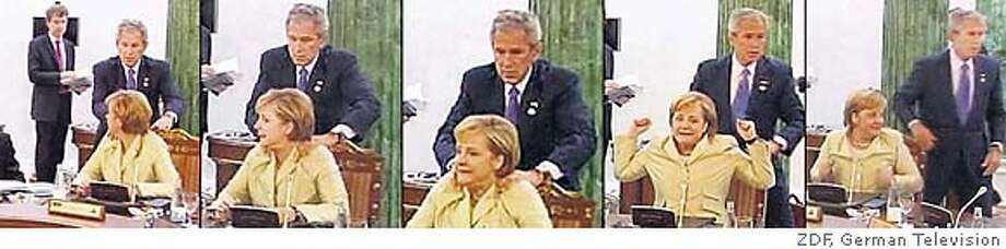 Video framegrab of President George W. Bush giving impromptu neck massage to German Chancellor Angela Merkel at the G8 Summit in St. Petersburg, Russia. Released July 18, 2006. Photo Credit: ZDF, German Television.