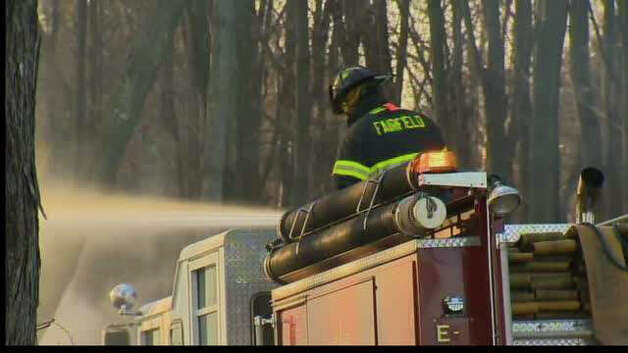 A brush fire in woods off the H Smith Richardson Golf Course was