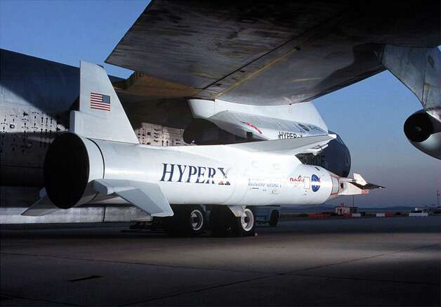 NASA's X-43A Hypersonic
 Experimental Vehicle is mated to the wing of the B-52 launch platform in an undated photo. The first X-43A was destroyed during its maiden flight on June 2, 2001,
 after a booster rocket carrying it aloft veered out of control and tumbled from the sky. Photo: NASA, Getty Images / Getty Images North
 America