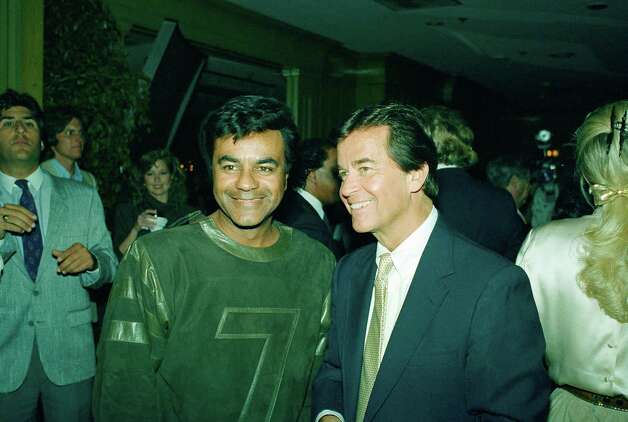 Johnny Mathis and Dick Clark are photographed at a party in Chasen's Restaurant  in the Los Angeles to honor Clark's program " American Bandstand." September 11, 1987. Photo: AP / 1987 AP