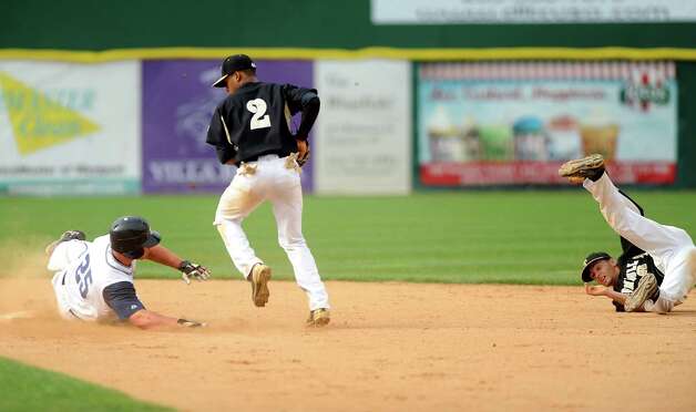 Staples' Zach Levins is safe at second base as Trumbull's Marcus Jenkins catches a pass from teammate Brandon Liscinsky, right, during the FCIAC baseball semifinals Thursday, May 24, 2012 at the Ballpark at Harbor Yard in Bridgeport, Conn. Photo: Autumn Driscoll / Connecticut Post