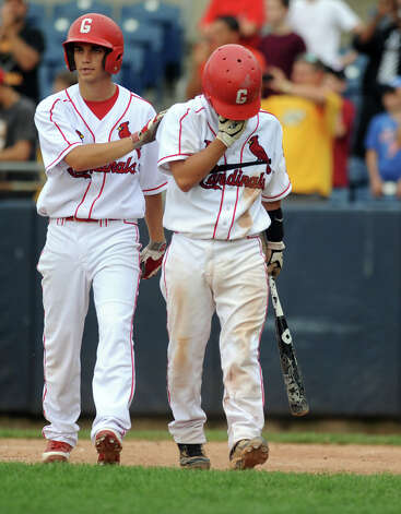 Greenwich's Ricky Okazaki gets a pat on the back from a teammate after his team lost Saturday's FCIAC baseball championship game to Trumbull at the Ballpark at Harbor Yard in Bridgeport on May 26, 2012. Photo: Lindsay Niegelberg / Stamford Advocate