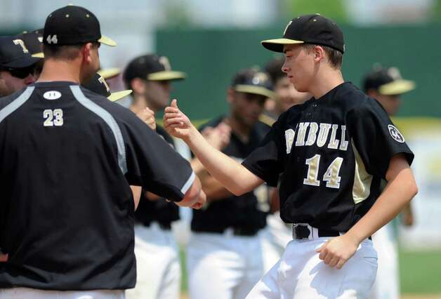 Trumbull's Carl Johnson gets a fist bump as his team is introduced during Saturday's FCIAC baseball championship game against Greenwich at the Ballpark at Harbor Yard in Bridgeport on May 26, 2012. Photo: Lindsay Niegelberg / Stamford Advocate
