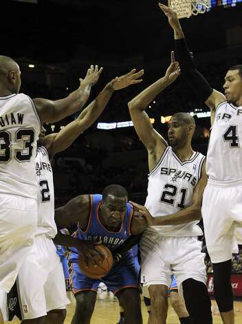 Oklahoma City Thunder's Kendrick Perkins (5) is under pressure from San Antonio Spurs' Boris Diaw (33), San Antonio Spurs' Kawhi Leonard (2), San Antonio Spurs' Tim Duncan (21) and San Antonio Spurs' Danny Green (4) during the first half of game two of the NBA Western Conference Finals in San Antonio, Texas on Tuesday, May 29, 2012. Kin Man Hui/Express-News (Kin Man Hui / San Antonio Express-News) / SA