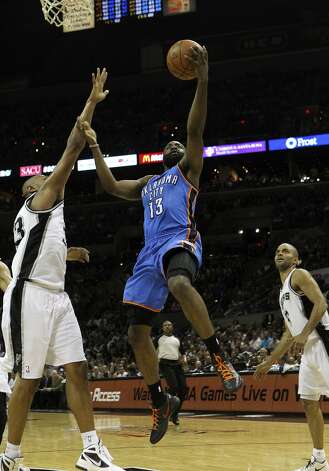 Oklahoma City Thunder's James Harden (13) lays the ball in against San Antonio Spurs' Boris Diaw (33) near San Antonio Spurs' Tony Parker (9) during the first half of game two of the NBA Western Conference Finals in San Antonio, Texas on Tuesday, May 29, 2012. Kin Man Hui/Express-News (Kin Man Hui / San Antonio Express-News) / SA