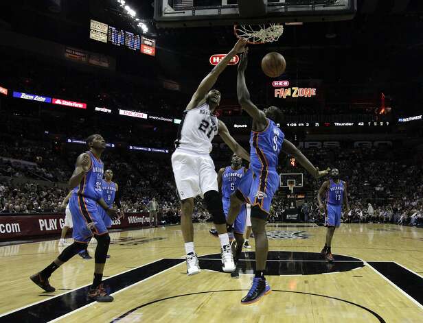 San Antonio Spurs' Tim Duncan (21) dunks against Oklahoma City Thunder's Serge Ibaka (9) during the first half of game two of the NBA Western Conference Finals in San Antonio, Texas on Tuesday, May 29, 2012. Kin Man Hui/Express-News (Kin Man Hui / San Antonio Express-News) / SA