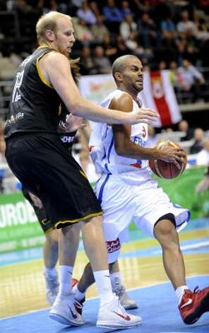 Tony Parker, right, of France vies with Chris Kaman of Germany during a 2011 European championship qualifying round, group B , basketball game in Siauliai on September 2, 2011. (Janek Skarzynski / AFP/Getty Images) / SA
