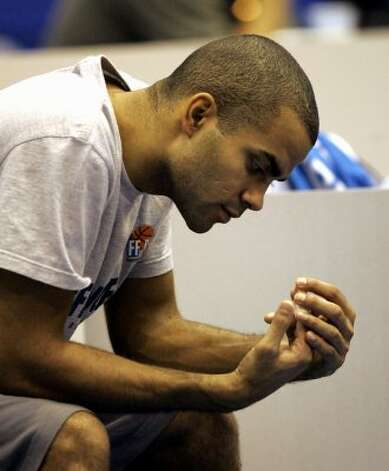 France's star player Tony Parker of the NBA's San Antonio Spurs checks out his brolen index finger during a practice session in Sendai, Japan, Friday Aug. 18, 2006. Parker will not play for France in the basketball world championships after being diagnosed with a broken finger. Parker had X-rays of his right index finger in Japan on Thursday and found out Friday that it was broken. (Dusan Vranic / Associated Press) / SA