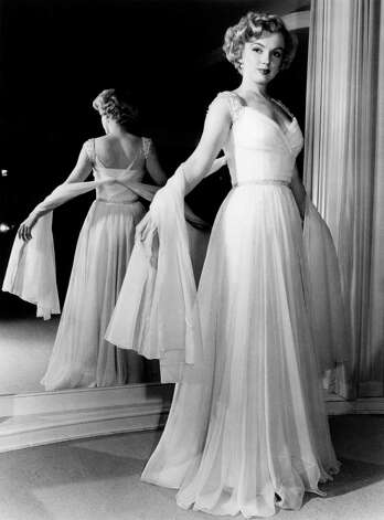 For a 1951 magazine layout, Marilyn Monroe models a pale blue chiffon goddess gown by Don Loper who catered to Hollywood royalty. / HC