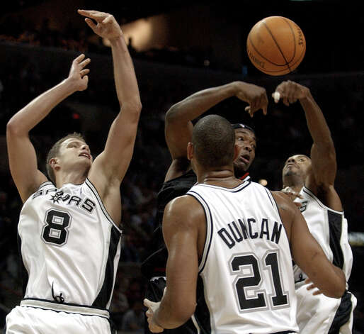 Spurs defenders Rasho Nesterovic (8), Tim Duncan (21) and Bruce Bowen (12) pressure Chicago Bulls center Eddy Curry during the fourth quarter in San Antonio, Wednesday, Nov. 26, 2003. Curry scored 19 points for the Bulls, but San Antonio won 109-98. (Eric Gay / Associated Press) Photo: ERIC GAY, AP / AP