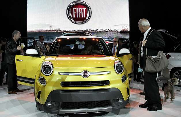 Attendees view the new Fiat 500L vehicle during the LA Auto Show in Los Angeles, California, U.S., on Wednesday, Nov. 28, 2012. After returning to the U.S. with its 500 subcompact in 2010, Fiat plans to introduce an electric version at the Los Angeles Auto Show today. Photo: Jonathan Alcorn, Bloomberg / SF