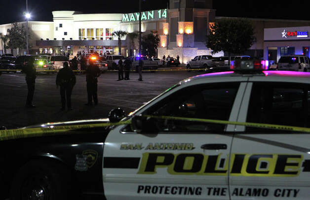 A recent breakup set off a shooting spree that ended with the suspect wounding a man at the Santikos Mayan Palace 14 movie theater Sunday night before being shot by an off-duty deputy, authorities said. Police are shown questioning men outside the theater Sunday night.. Jesus Manuel Garcia, 19, an employee at a nearby China Garden restaurant, apparently became upset Sunday night after his girlfriend broke up with him. Photo: JOHN DAVENPORT, San Antonio Express-News / San Antonio Express-News