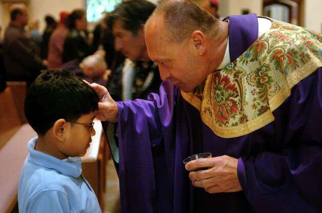 During the noontime Ash Wednesday mass at St. Augustine's Cathedral in Bridgeport, Conn. on Feb. 6th, 2008, Monsignor Kevin Wallin, Pastor at St. Augustine's, distributed ashes to the students of St. Augustine School. Photo: File Photo/Tracy Deer-Mirek, File Photo / Connecticut Post File Photo