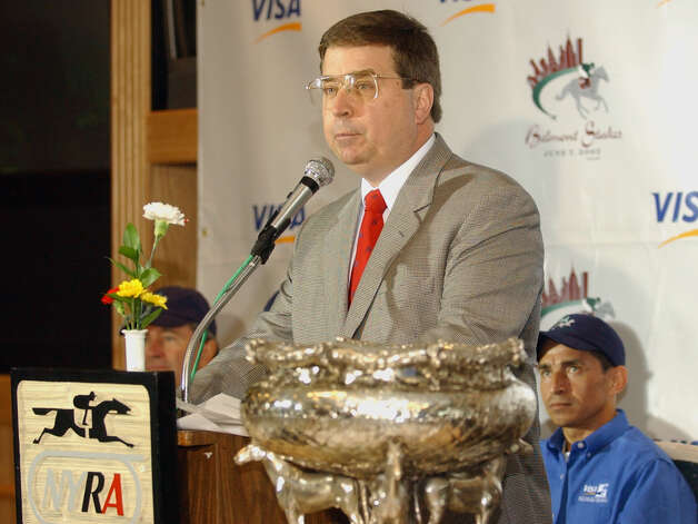 N.Y.R.A. president Terry Meyocks speaks at a news conference announcing the post position draw as Funny Cide jockey Jose Santos, right, looks on Wednesday, June 4, 2003 at Belmont Park in Elmont, N.Y. (AP Photo/Frank Franklin II) Photo: FRANK FRANKLIN II / AP