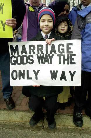 A boy holds a sign in front of the Massachusetts State House after a state supreme court decision made the Bay State first-in-the-nation to legalize gay marriage.  Lawmakers were considering a proposed amendment defining marriage as a union between a man and a woman. 