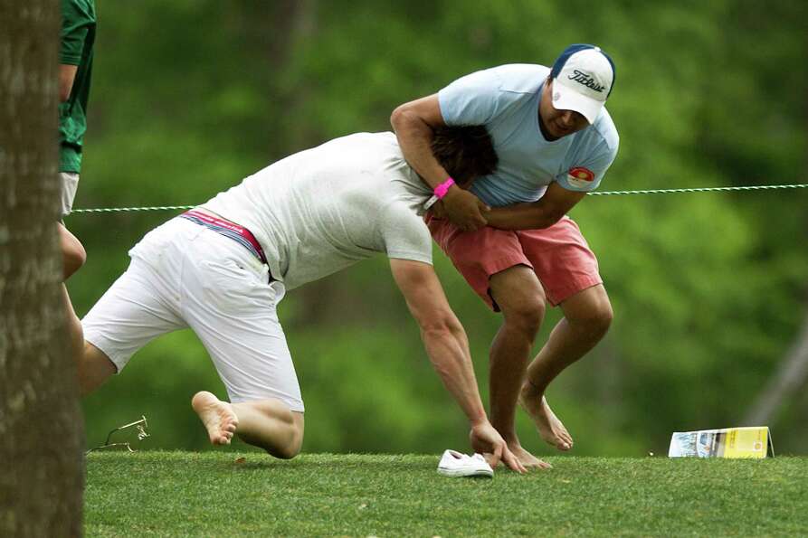 A pair of golf fans get into an altercation along the 15th fairway during the final round of the She