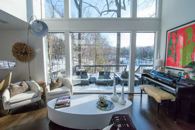 A home on Fox Run Road in New Canaan, nestled among woods and overlooking Paradise Pond, has spectacular views from all angles. Photo: Contributed