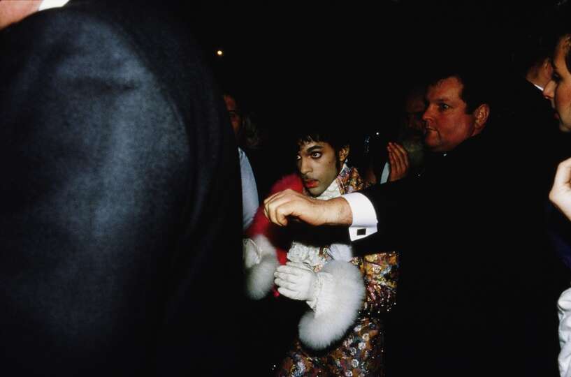 American singer, songwriter and musician Prince stands up to collect the award for Best Internationa