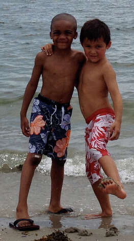 Isaiah Foster, left, a Fresh Air Fund child from Brooklyn, N.Y., plays with Nicolas Blanco of Westport at Westport's Compo Beach last summer. Blanco's family hosted Foster for a week last August and plan on taking him in again this summer in late July. Photo: Contributed Photo