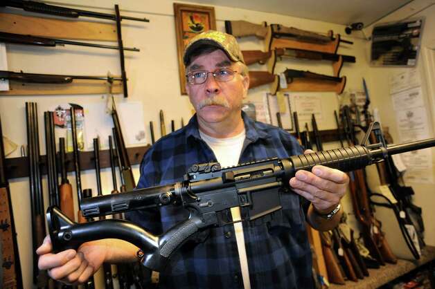 Shop owner Rich Sehlmeyer holds an AR-15 assault-style rifle with a compliant stock on Saturday, May 25, 2013, at The Gun Shop in Lake Luzerne, N.Y. (Cindy Schultz / Times Union) Photo: Cindy Schultz / 00022567A