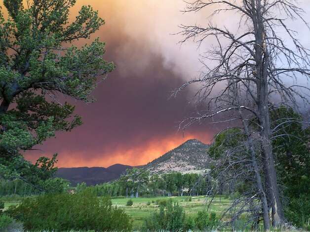 In this Thursday, June 20, 2013 photo provided by the U.S. Forest Service, wildfires fires approach the town of South Fork, Colo. The town of about 400 people was evacuated Friday morning, June 21, 2013. (AP Photo/U.S. Forest Service, Penny Bertram) Photo: Penny Bertram, Associated Press