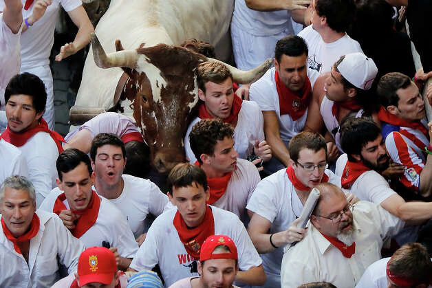 Steers make their way through a crowd of runners after the Alcurrucen's ranch fighting bulls entered the bullring during the second day of the San Fermin Running Of The Bulls festival on July 7, 2013 in Pamplona, Spain. The annual Fiesta de San Fermin, made famous by the 1926 novel of US writer Ernest Hemmingway 'The Sun Also Rises', involves the running of the bulls through the historic heart of Pamplona, this year for nine days from July 6-14. Photo: Pablo Blazquez Dominguez, Getty Images / 2013 Getty Images