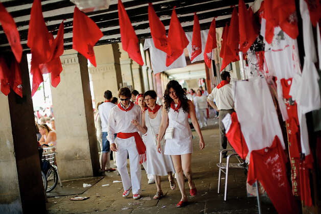 People walk in the streets after the Alcurrucen's ranch fighting bulls running during the second day of the San Fermin Running Of The Bulls festival on July 7, 2013 in Pamplona, Spain. The annual Fiesta de San Fermin, made famous by the 1926 novel of US writer Ernest Hemmingway 'The Sun Also Rises', involves the running of the bulls through the historic heart of Pamplona, this year for nine days from July 6-14. Photo: Pablo Blazquez Dominguez, Getty Images / 2013 Getty Images