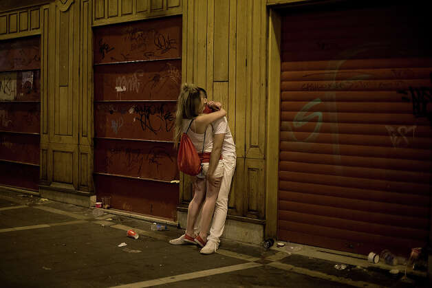 Revellers kiss on the street in the early hours ahead of Dolores Aguirre's ranch fighting bulls running on the third day of the San Fermin Running Of The Bulls festival, on July 8, 2013 in Pamplona, Spain. The annual Fiesta de San Fermin, made famous by the 1926 novel of US writer Ernest Hemmingway 'The Sun Also Rises', involves the running of the bulls through the historic heart of Pamplona for nine days from July 6-14. Photo: Pablo Blazquez Dominguez, Getty Images / 2013 Getty Images