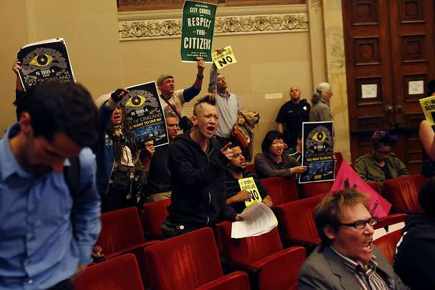 Audience members react after the City Council voted yes to the creation of the Domain Awareness Center during a city council meeting at the Oakland City Hall in Oakland, Calif. on July 30, 2013. Photo: Ian C. Bates, The Chronicle