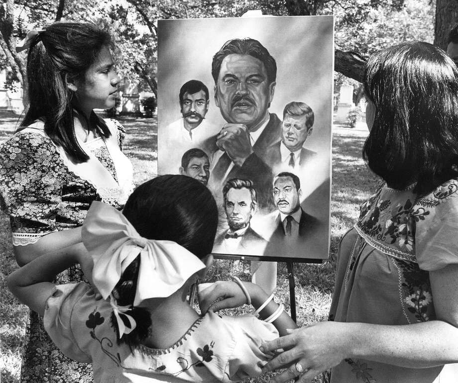 Catarina Velásquez admires a painting of her  father, Southwest Voter Registration Project founder Willie Velasquez, in  1988, four months after his death. Photo: File Photo