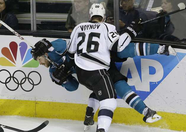 San Jose Sharks' Andrew Desjardins collides against the boards with Los Angeles Kings' Slava Voynov (26), of Russia, during the first period of an NHL hockey game on Monday, Jan. 27, 2014, in San Jose, Calif. (AP Photo/Marcio Jose Sanchez) Photo: Marcio Jose Sanchez, Associated Press