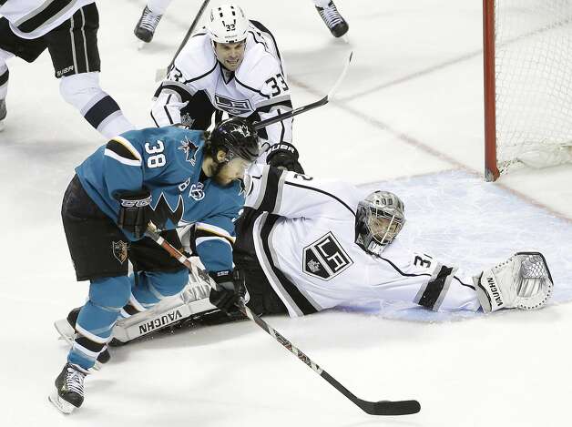Los Angeles Kings goalie Jonathan Quick, right, dives to cutoff the shooting angle from San Jose Sharks center Bracken Kearns (38) during the first period of an NHL hockey game on Monday, Jan. 27, 2014, in San Jose, Calif. (AP Photo/Marcio Jose Sanchez) Photo: Marcio Jose Sanchez, Associated Press
