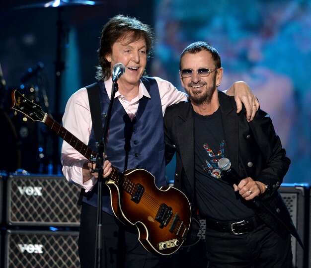 Recording artists Paul McCartney (L) and Ringo Starr perform onstage during 