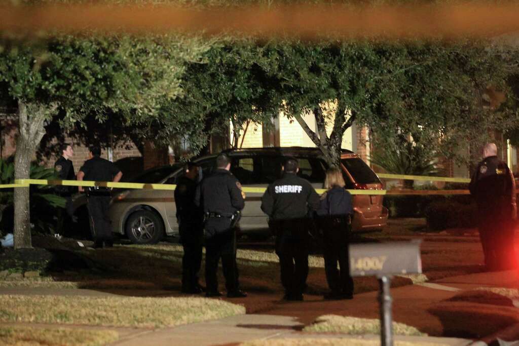 Officers work the scene in the 14000 block of Fosters Creek in northwest Harris County where sheriff's deputies said  four people were found dead at a home on Thursday, Jan. 30, 2014, in Houston. Photo: Karen Warren, Houston Chronicle / © 2014  Houston Chronicle