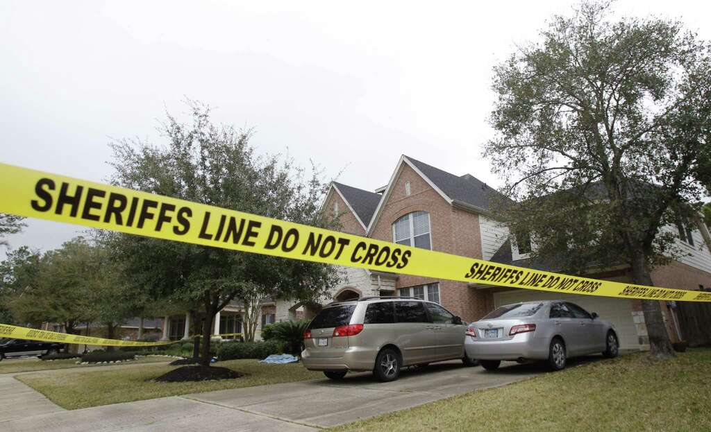 Crime scene tape surrounds a home at 14015 Fosters Creek Dr. Friday, Jan. 31, 2014 in Cypress where four people where found dead on Thursday. Photo: Melissa Phillip